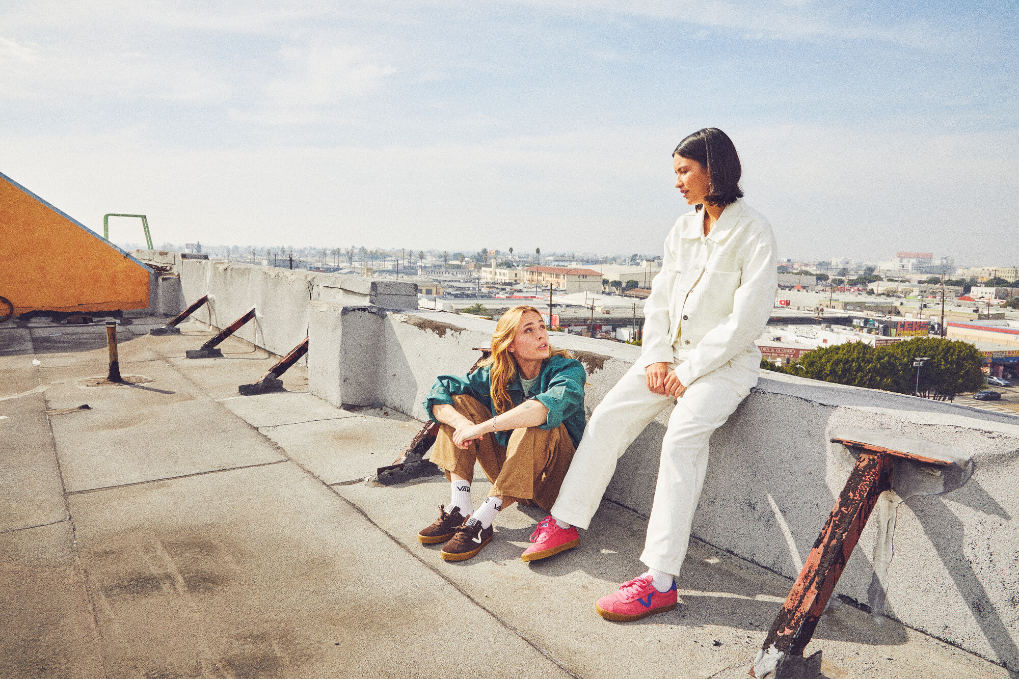 Two people wearing Vans on a rooftop